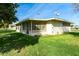 Ranch-style home with a screened patio and grassy yard at 10801 W Clair Dr, Sun City, AZ 85351