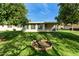 Rear view of house showing patio and mature trees at 10801 W Clair Dr, Sun City, AZ 85351