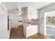 Kitchen with white cabinets, tile floor and island counter at 10801 W Clair Dr, Sun City, AZ 85351