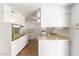 Kitchen with white cabinets, tile floor and island counter at 10801 W Clair Dr, Sun City, AZ 85351