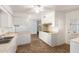 Kitchen with white cabinets, tile floor and island counter at 10801 W Clair Dr, Sun City, AZ 85351