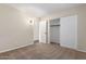 Bright bedroom with carpet, double closet, and access to a hallway at 11085 E Becker E Ln, Scottsdale, AZ 85259