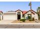 Single-story home with red tile roof, desert landscaping, and a two-car garage at 11085 E Becker E Ln, Scottsdale, AZ 85259