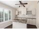 Kitchen with granite island and white cabinets at 11085 E Becker E Ln, Scottsdale, AZ 85259