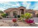 Single-story home with desert landscaping and a two-car garage at 14604 N 100Th Pl, Scottsdale, AZ 85260