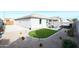 Landscaped backyard with artificial turf, hot tub, and patio furniture at 18157 W Foothill Dr, Surprise, AZ 85387
