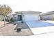 Single-story home with attached garage and desert landscaping at 18157 W Foothill Dr, Surprise, AZ 85387