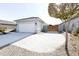 View of garage and gated side yard with gravel at 18157 W Foothill Dr, Surprise, AZ 85387