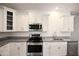 White shaker cabinets, granite countertops, and stainless steel appliances at 18157 W Foothill Dr, Surprise, AZ 85387