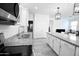 Kitchen features granite countertops, stainless steel appliances, and white cabinets at 18157 W Foothill Dr, Surprise, AZ 85387