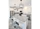Modern kitchen with island, white cabinets, and granite countertops at 18157 W Foothill Dr, Surprise, AZ 85387