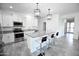 Open concept kitchen with island, stainless steel appliances, and granite countertops at 18157 W Foothill Dr, Surprise, AZ 85387
