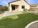 Home with grassy backyard, patio, and artificial turf at 18471 W Ida Ln, Surprise, AZ 85387