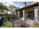 Brick paved patio with wrought iron railings and lush landscaping at 20402 N 100Th Pl # 1326, Scottsdale, AZ 85255