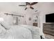 Main bedroom with barn doors leading to private bathroom and patio at 2854 E Mallory St, Mesa, AZ 85213
