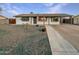 House exterior with a gravel driveway and American flag at 3344 W Oraibi Dr, Phoenix, AZ 85027