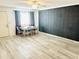 Dining area with light gray wood-look flooring and a dark gray accent wall at 4501 E Carol Ave # 74, Mesa, AZ 85206