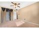 Bedroom with carpet, ceiling fan and built-in shelves at 5203 E Saguaro Cir, Phoenix, AZ 85044