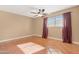 Bedroom with tile floors, window, and burgundy curtains at 5203 E Saguaro Cir, Phoenix, AZ 85044