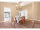 Open dining area with chandelier, table, and view into kitchen at 5203 E Saguaro Cir, Phoenix, AZ 85044