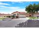 Single story home with a two car garage and desert landscaping at 5203 E Saguaro Cir, Phoenix, AZ 85044