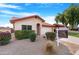 Tan house with red tile roof and attached garage, for sale sign at 5203 E Saguaro Cir, Phoenix, AZ 85044