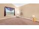 Living room with a comfortable chair, floor lamp, and large window at 5203 E Saguaro Cir, Phoenix, AZ 85044