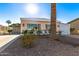 Front view of a manufactured home with a carport and palm trees at 5807 E Leonora St, Mesa, AZ 85215