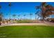 Scenic golf course view with palm trees and mountains in the background at 5807 E Leonora St, Mesa, AZ 85215