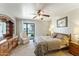 Spacious bedroom with patio access and built-in wooden furniture at 635 S 79Th Pl, Mesa, AZ 85208