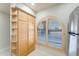 View of kitchen cabinets and arched window with shutters at 635 S 79Th Pl, Mesa, AZ 85208
