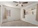 Bright bedroom with ceiling fan and neutral carpeting at 7125 N 25Th Dr, Phoenix, AZ 85051