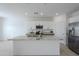 Modern kitchen with granite island and stainless steel fridge at 8197 W Pica Dr, Arizona City, AZ 85123