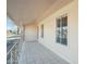 Covered porch with tiled flooring and wrought-iron railing at 9725 W Pineaire Dr, Sun City, AZ 85351