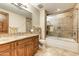 Bathroom with granite countertop, large bathtub, and walk-in shower at 9749 N Fireridge Trl, Fountain Hills, AZ 85268