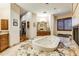 Elegant bathroom with a granite countertop, large tub, and walk-in closet at 9749 N Fireridge Trl, Fountain Hills, AZ 85268