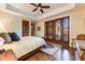 Comfortable bedroom with hardwood floors, french doors, and a ceiling fan at 9749 N Fireridge Trl, Fountain Hills, AZ 85268