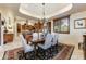 Bright dining room with hardwood floors and kitchen views at 9749 N Fireridge Trl, Fountain Hills, AZ 85268
