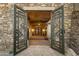 Ornate metal gates open to a grand entryway with a tile floor at 9749 N Fireridge Trl, Fountain Hills, AZ 85268