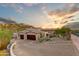 Two-car garage with a large driveway and mountain views in the background at 9749 N Fireridge Trl, Fountain Hills, AZ 85268