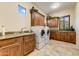 Laundry room with granite countertops and wood cabinets at 9749 N Fireridge Trl, Fountain Hills, AZ 85268
