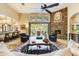 Living room with stone fireplace, access to patio, and high ceilings at 9749 N Fireridge Trl, Fountain Hills, AZ 85268