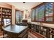 Spacious home office with large desk, built-in bookshelves, and hardwood floors at 9749 N Fireridge Trl, Fountain Hills, AZ 85268