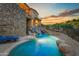 Luxury pool and waterfall at sunset at 9749 N Fireridge Trl, Fountain Hills, AZ 85268