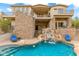 Luxury pool with a waterfall feature and lounge chairs at 9749 N Fireridge Trl, Fountain Hills, AZ 85268