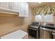 Laundry room with built-in cabinets, washer, and dryer at 14414 N 57Th Way, Scottsdale, AZ 85254
