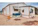 Rear view of manufactured home showcasing AC unit and landscaping at 17200 W Bell Rd # 1740, Surprise, AZ 85374