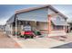 Inviting exterior of manufactured home with carport and golf cart at 17200 W Bell Rd # 1740, Surprise, AZ 85374