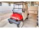Red golf cart parked under covered area at 17200 W Bell Rd # 1740, Surprise, AZ 85374