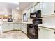 Kitchen with light cabinets, black appliances, and tile floors at 17200 W Bell Rd # 1740, Surprise, AZ 85374